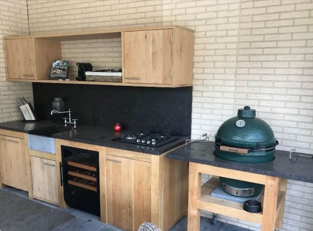 Outdoor kitchen with wooden cupboards, a hob and on the right a beer storage cupboard (105 litres, height 84cm).