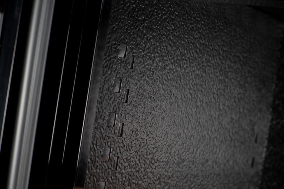 Close-up of a structured black surface with relief letters, possibly part of a Bier climate chamber (190 liters, height 124 cm, multiple zones).