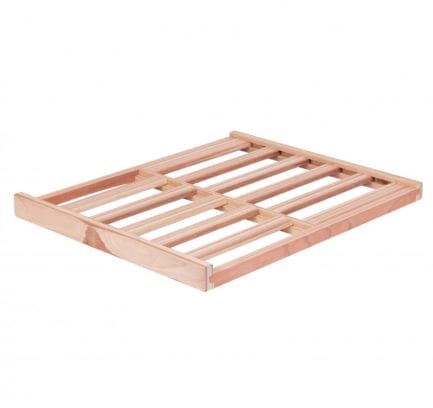 Wooden bed frame base made of light, unfinished pine wood, with closely spaced slats, isolated on a white background.