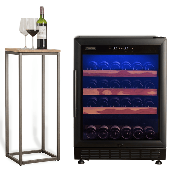 A wine cooler with an illuminated interior with rows of wine bottles, next to a table with two wine glasses and a bottle of wine.