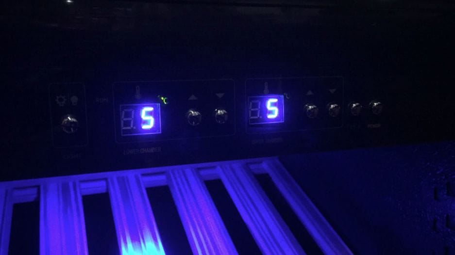 Control panel of a device with blue backlight, displaying settings and numerical values.